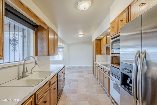 kitchen with light tile patterned flooring, sink, and black appliances