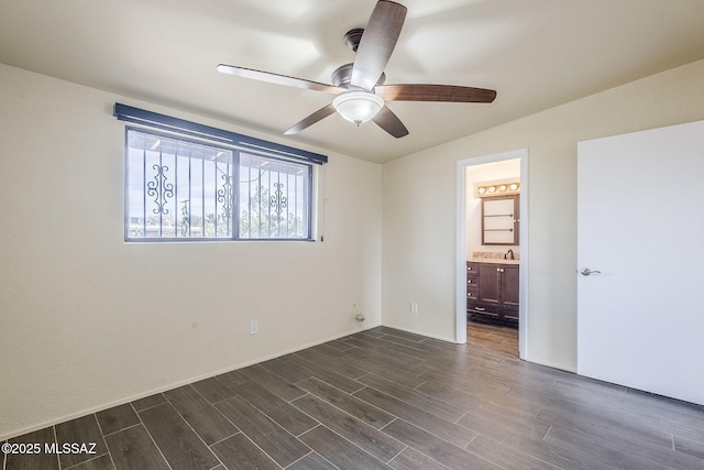 unfurnished bedroom featuring connected bathroom, sink, and ceiling fan