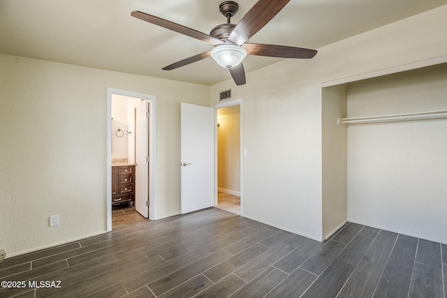 unfurnished bedroom with ceiling fan, connected bathroom, dark hardwood / wood-style flooring, and a closet