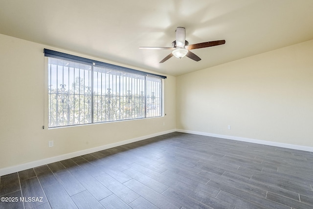 spare room featuring dark hardwood / wood-style flooring and ceiling fan