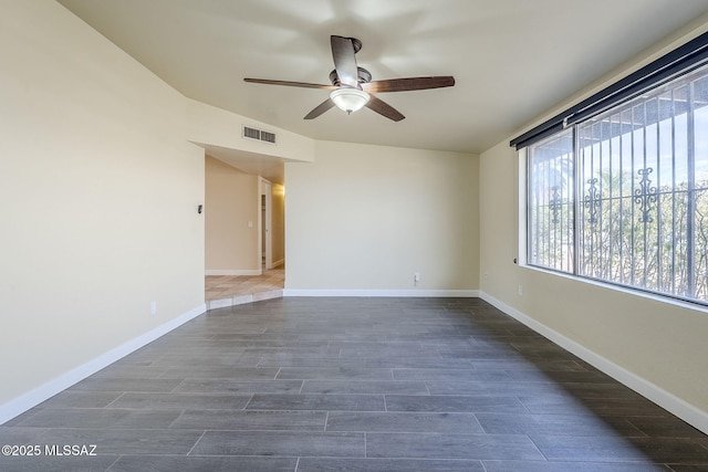 empty room featuring ceiling fan and dark hardwood / wood-style flooring