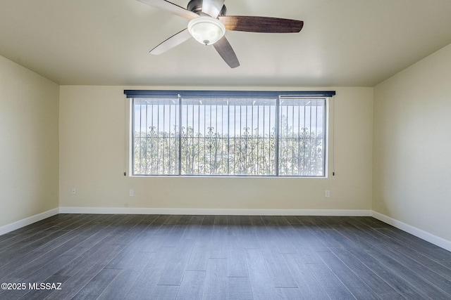 unfurnished room featuring dark hardwood / wood-style floors, a wealth of natural light, and ceiling fan