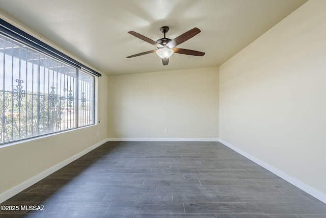 unfurnished room featuring ceiling fan and dark hardwood / wood-style floors