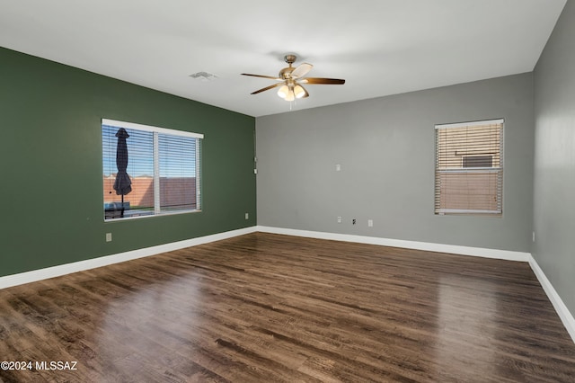 unfurnished room with dark wood-type flooring and ceiling fan