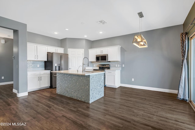 kitchen with white cabinetry, stainless steel appliances, sink, and a center island with sink