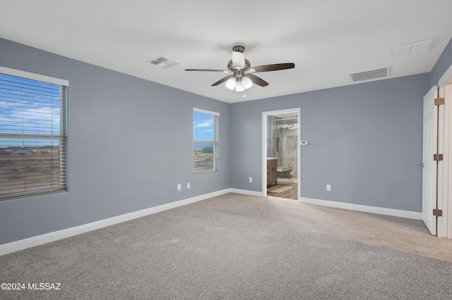 carpeted spare room with ceiling fan