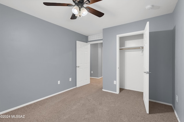 unfurnished bedroom featuring light colored carpet, a closet, and ceiling fan