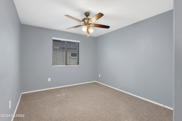 spare room featuring carpet floors and ceiling fan