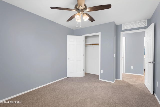 unfurnished bedroom featuring ceiling fan, a closet, and light carpet