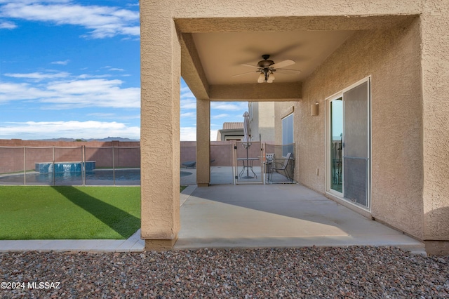 view of patio featuring ceiling fan