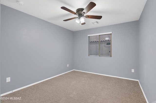 carpeted empty room featuring ceiling fan