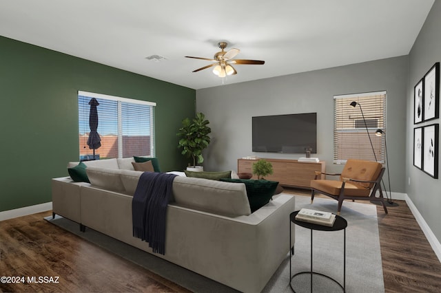 living room with dark wood-type flooring and ceiling fan