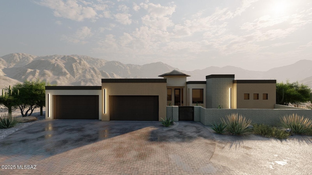 802 E Canyon Rock Rd, Green Valley, AZ 85614 - view of front of house with a mountain view, a garage, stucco siding, and decorative driveway