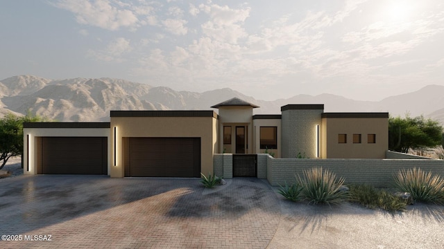 view of front of property with a mountain view and a garage