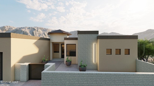 802 E Canyon Rock Rd, Green Valley, AZ 85614 - modern home with a mountain view, stucco siding, a patio, and brick siding