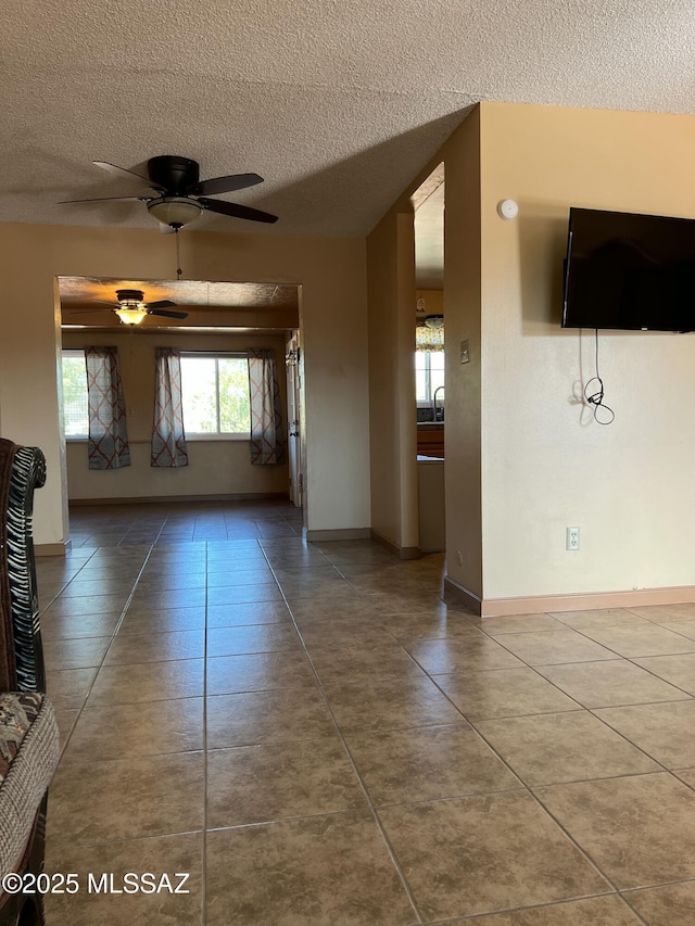177 N Abrego Dr, Green Valley, AZ 85614 - corridor featuring tile patterned flooring, a sink, baseboards, and a textured ceiling