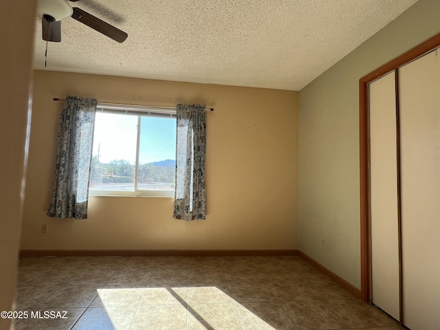 177 N Abrego Dr, Green Valley, AZ 85614 - interior space with a closet, a textured ceiling, baseboards, tile patterned floors, and a ceiling fan