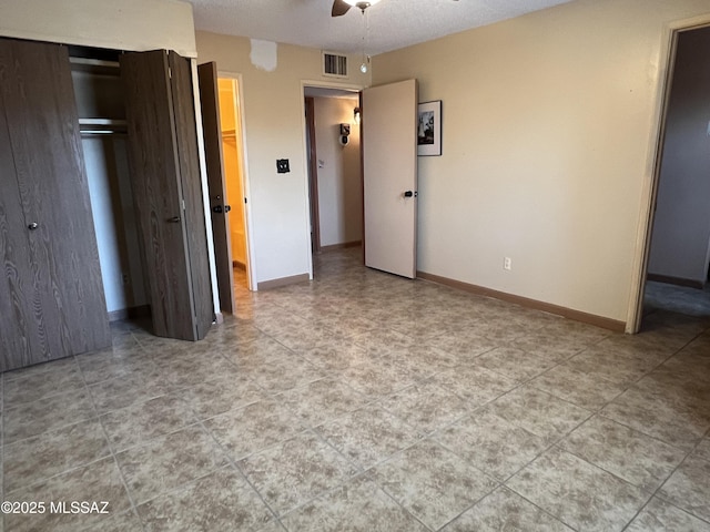 177 N Abrego Dr, Green Valley, AZ 85614 - unfurnished bedroom with baseboards, visible vents, a closet, and a ceiling fan
