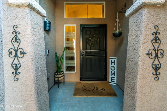 property entrance with stucco siding