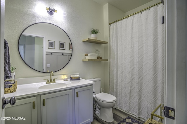 full bath featuring wood finished floors, toilet, and vanity