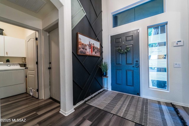 entrance foyer with visible vents, baseboards, washer / dryer, and dark wood-style flooring