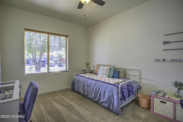 bedroom with a ceiling fan, carpet flooring, and baseboards