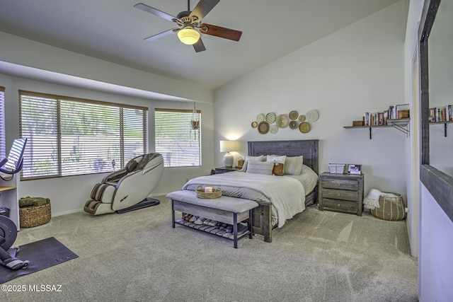 bedroom with lofted ceiling, a ceiling fan, multiple windows, and carpet