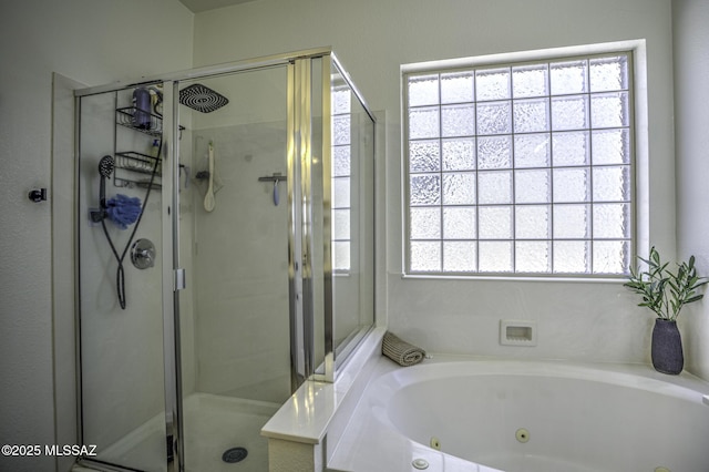full bathroom with a jetted tub and a shower stall