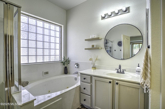 bathroom with vanity, a shower stall, and plenty of natural light