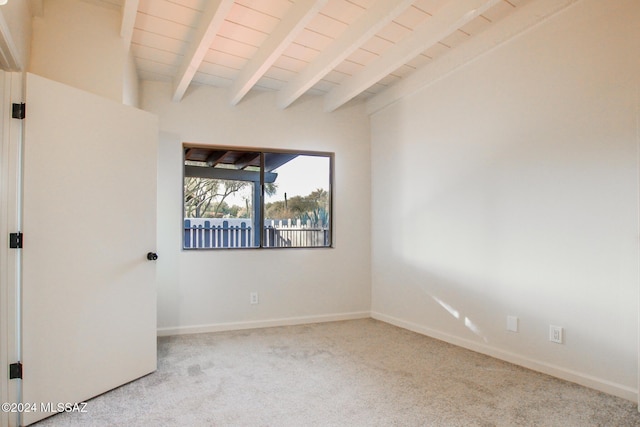 unfurnished room featuring beamed ceiling, light colored carpet, and wood ceiling