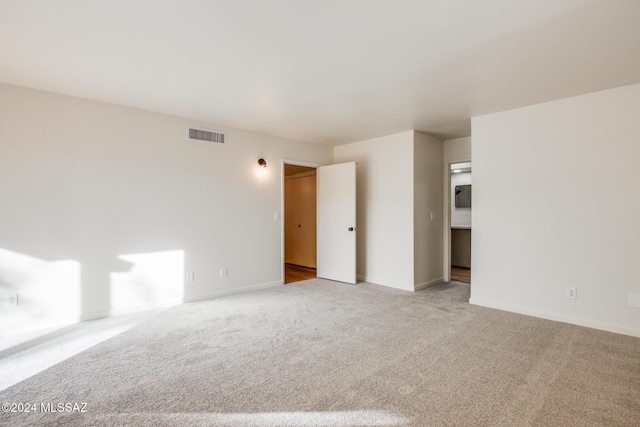 empty room featuring light carpet