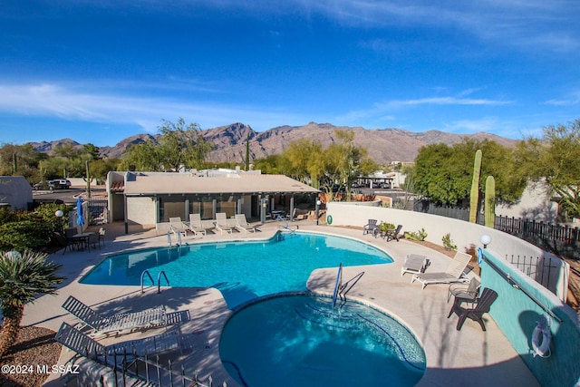 view of swimming pool with a mountain view and a patio