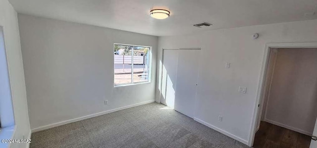 unfurnished bedroom featuring a closet and carpet