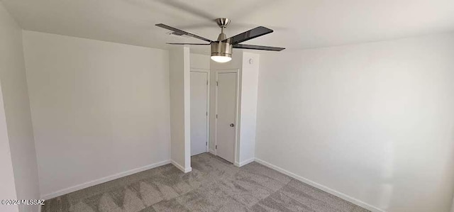 unfurnished bedroom with light colored carpet, a closet, and ceiling fan