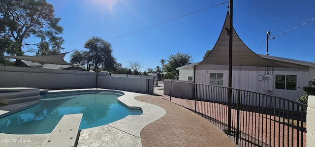 view of swimming pool with a diving board