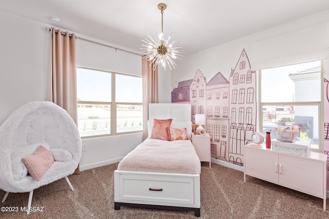 bedroom featuring baseboards, dark carpet, and an inviting chandelier