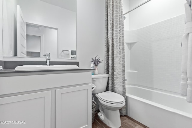 full bathroom featuring shower / bath combination with curtain, visible vents, toilet, vanity, and wood finished floors