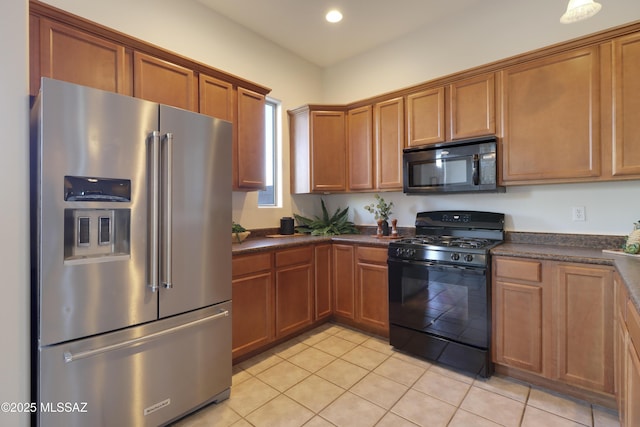 kitchen featuring light tile patterned flooring and black appliances