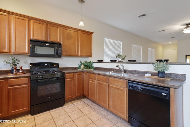 kitchen with sink, decorative light fixtures, light tile patterned floors, kitchen peninsula, and black appliances