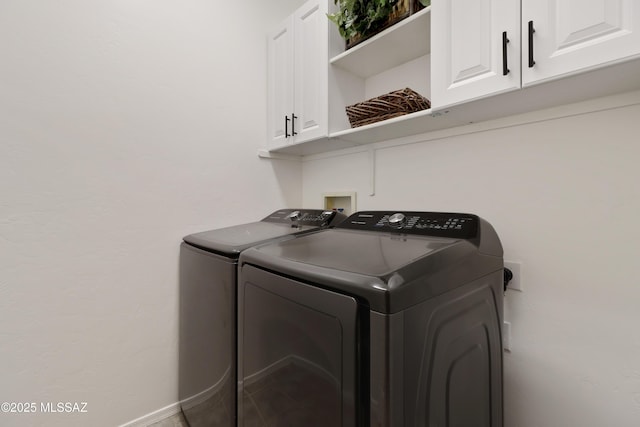 laundry area featuring cabinets and washing machine and clothes dryer