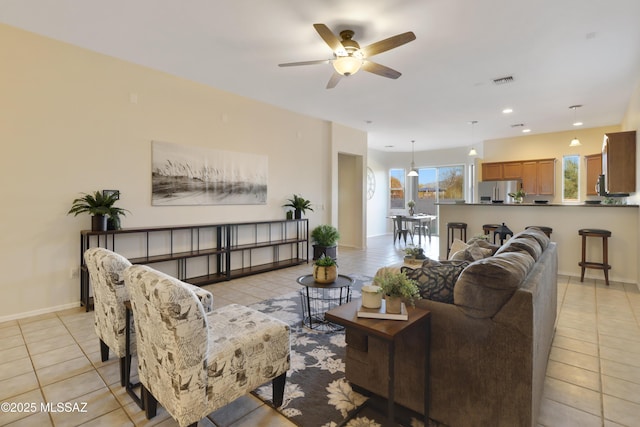 living room featuring ceiling fan and light tile patterned floors