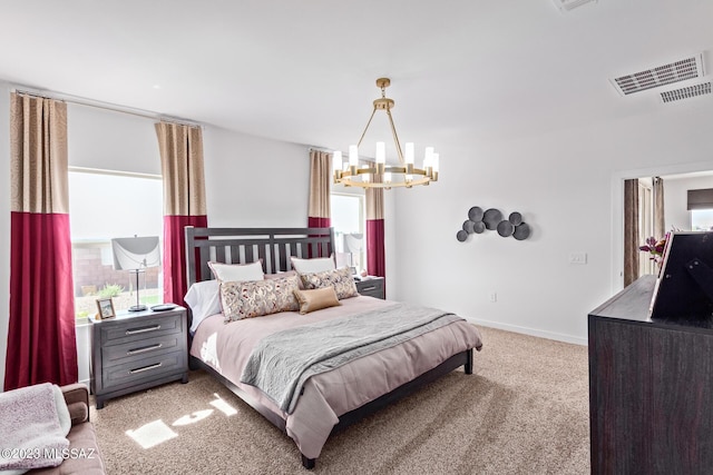 carpeted bedroom with an inviting chandelier, baseboards, and visible vents