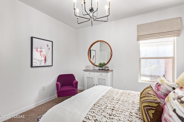 carpeted bedroom featuring baseboards and a chandelier