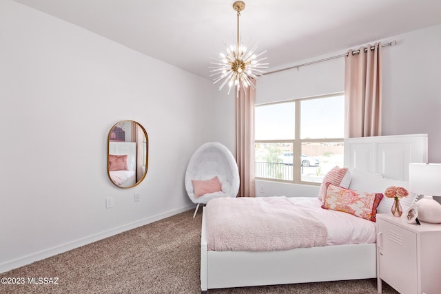 carpeted bedroom featuring an inviting chandelier and baseboards