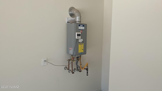 utility room featuring tankless water heater