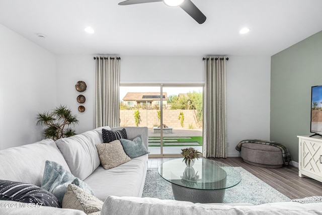 living room featuring hardwood / wood-style floors and ceiling fan