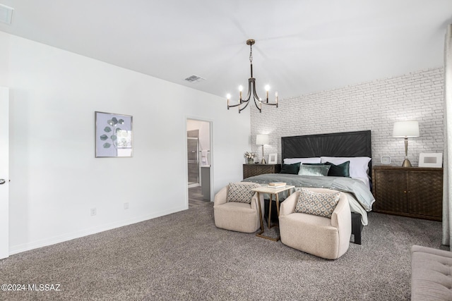 bedroom featuring an inviting chandelier, brick wall, ensuite bathroom, and carpet floors