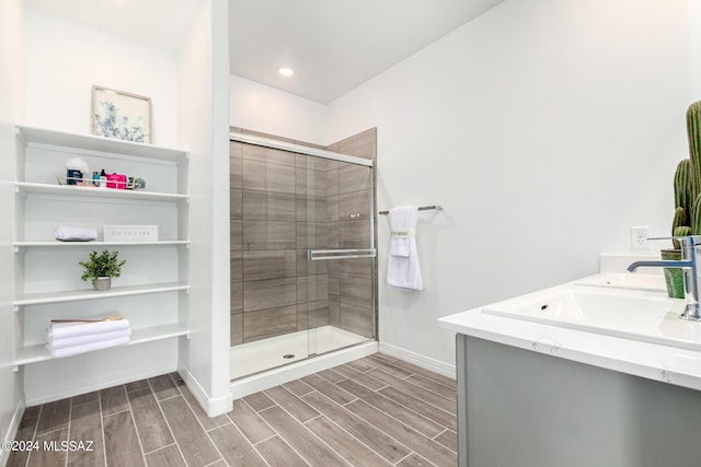 bathroom with walk in shower and vanity