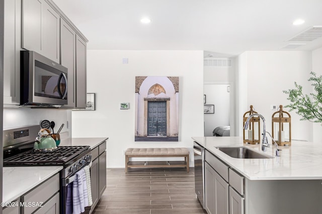 kitchen featuring gray cabinetry, sink, and stainless steel appliances