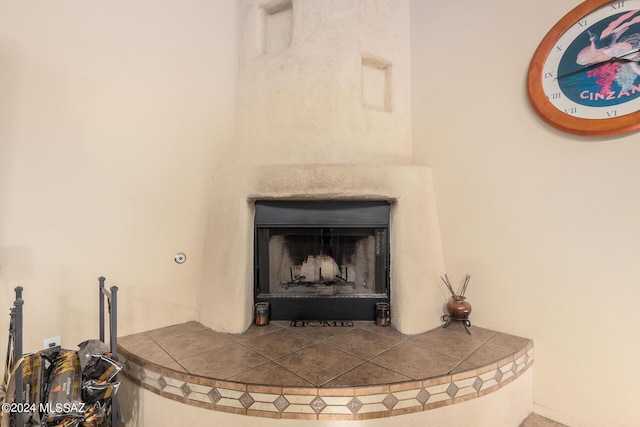 details with a tiled fireplace